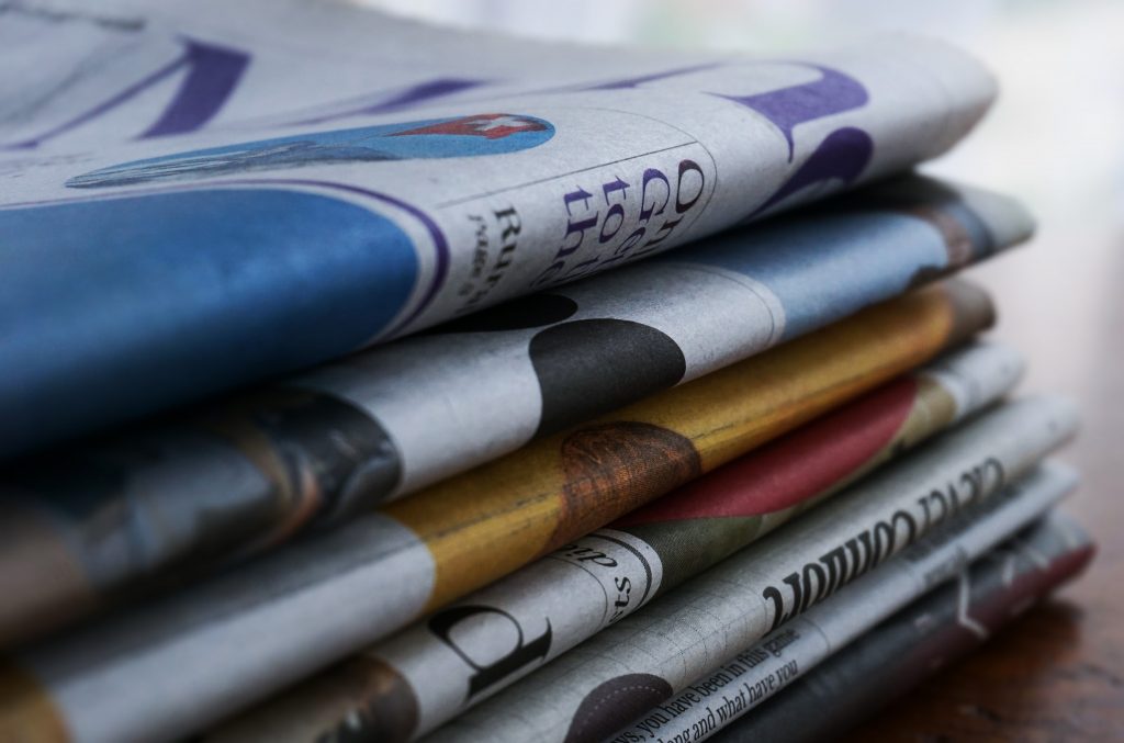 a stack of colourful newspapers